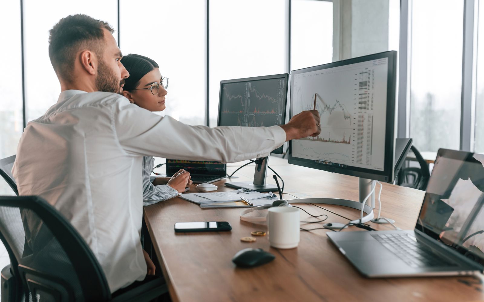 Two clinicians reviewing a provider workflow at a workstation